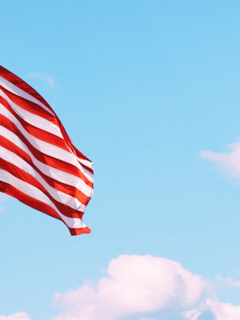 Flag of U.S.A. under white clouds during daytime