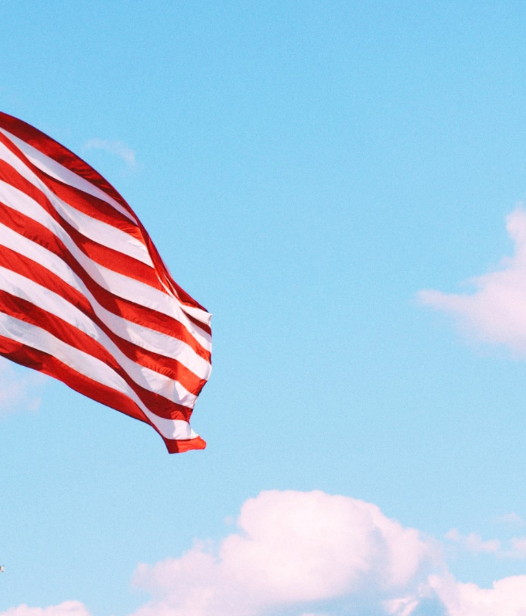 Flag of U.S.A. under white clouds during daytime