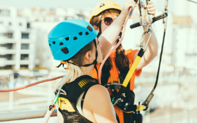 Two woman wearing harness during daytime