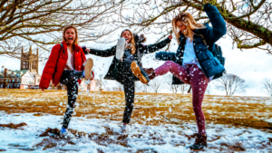 Women kicking snow