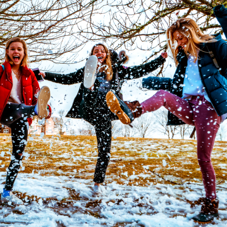 Women kicking snow