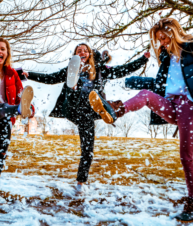 Women kicking snow