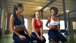 Three women kneeling inside building at daytime