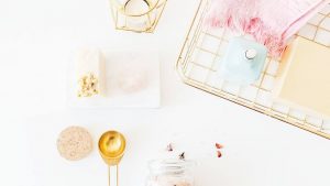 spray bottles on rack beside lamp and dessert photo