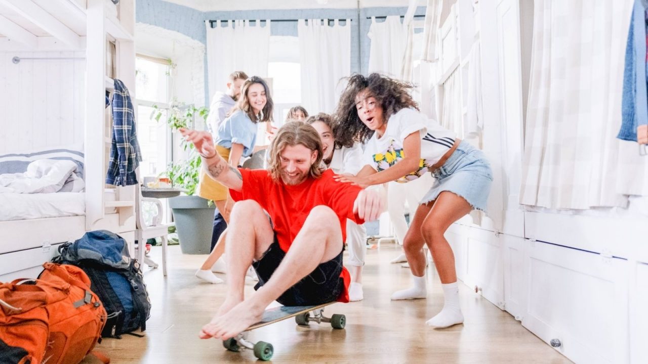 me in red shirt sitting on skateboard