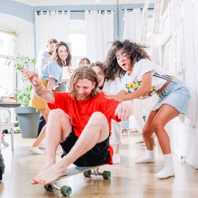 me in red shirt sitting on skateboard