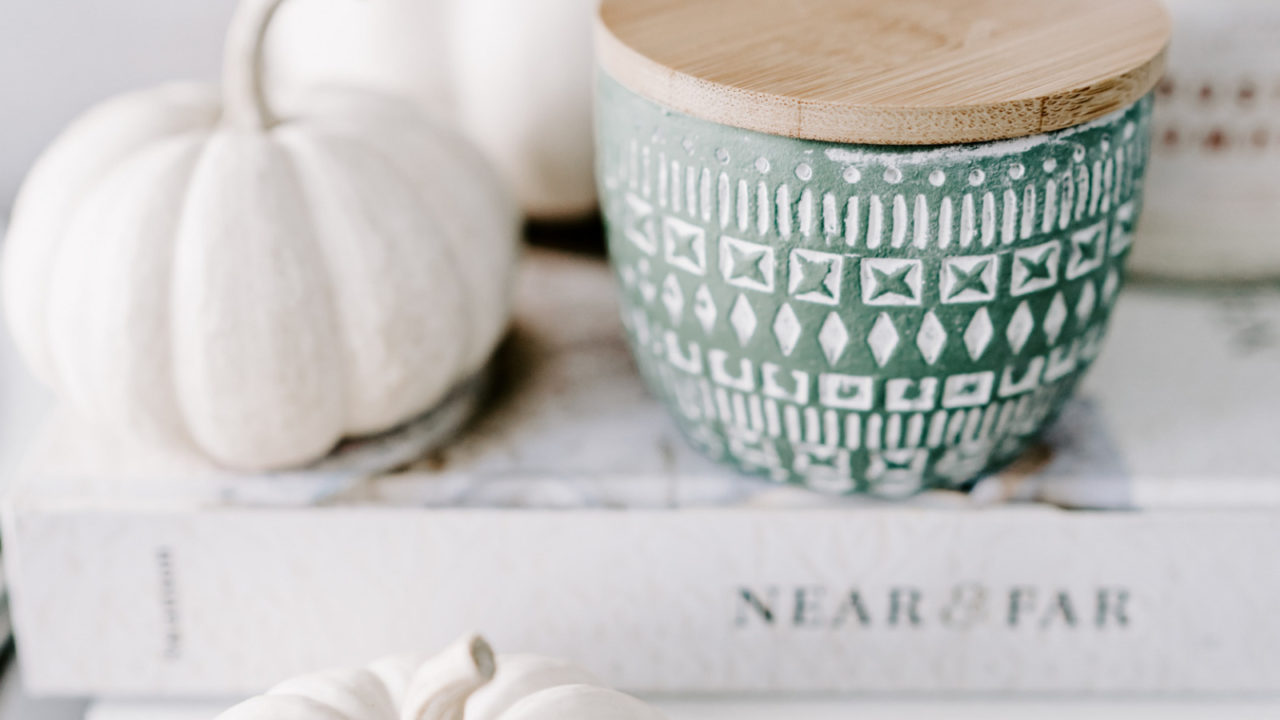 white pumpkins on stack of books