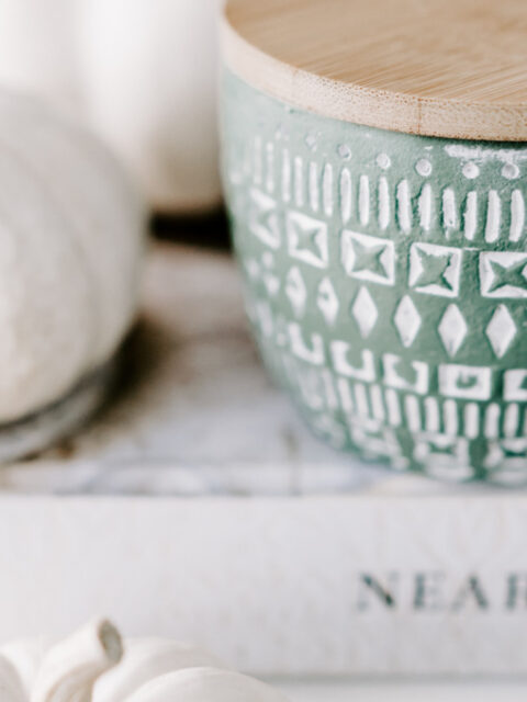 white pumpkins on stack of books