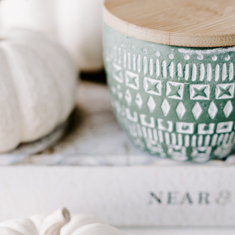 white pumpkins on stack of books