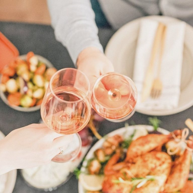 Food On The Table With Two People Having Wine